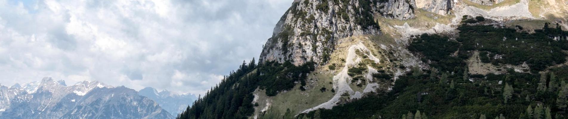Breathtaking view of rugged mountains and lush forests at Achensee, Tirol, Austria.