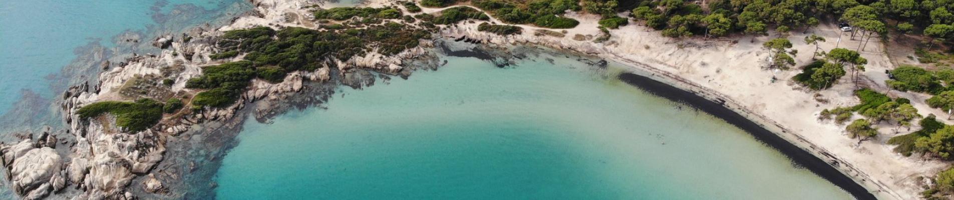 Discover the stunning beaches and vibrant sea of Sithonia, Halkidiki, Greece from above.