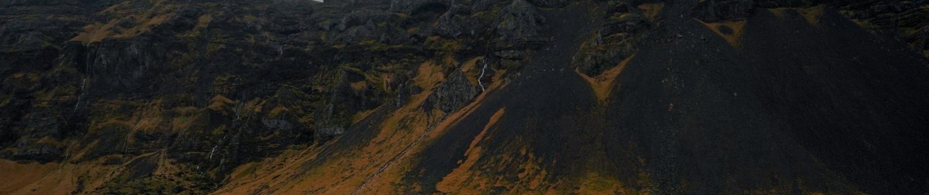 Majestic view of Iceland's rugged hills on a cloudy day, showcasing nature's raw beauty.