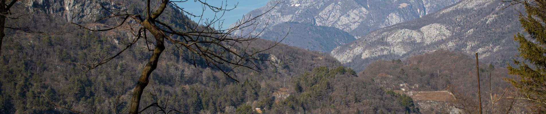 Breathtaking winter landscape of Lago di Cavazzo with snowy mountains in Friuli-Venezia Giulia, Italy.