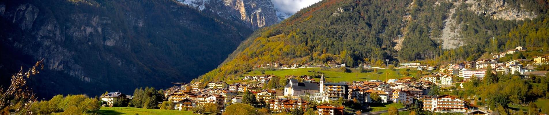 Beautiful autumn view of Molveno village and lake with mountains in Trentino, Italy.