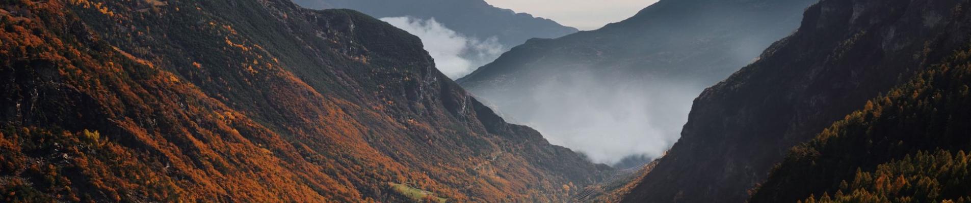 Idyllic autumn landscape in Valle d'Aosta, Italy with colorful foliage and mountain vistas.