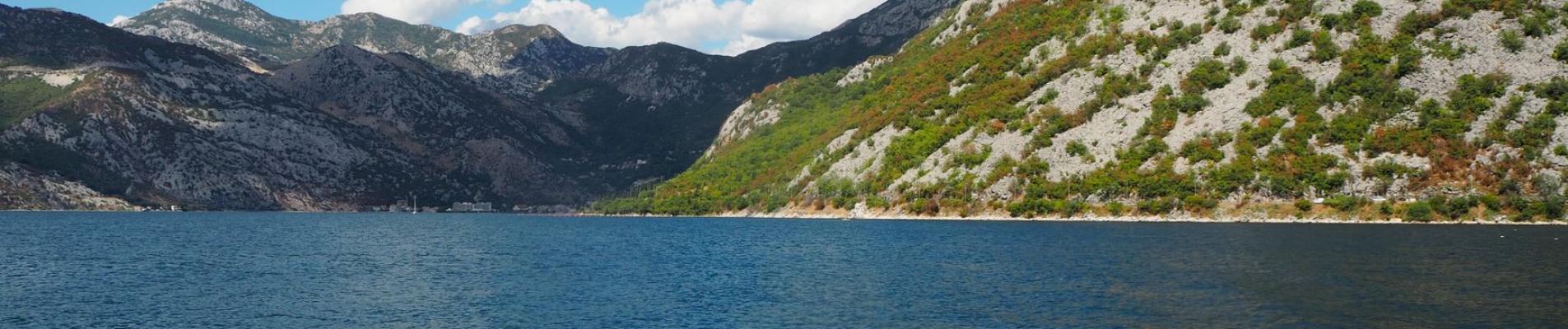 Beautiful landscape of the Bay of Kotor with mountains and blue skies in Montenegro.