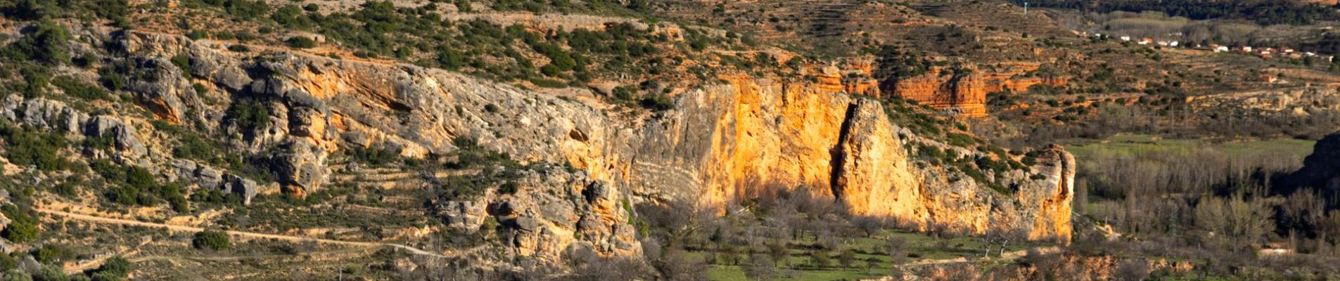 Picturesque view of rugged cliffs and greenery in a mountain landscape during daytime.