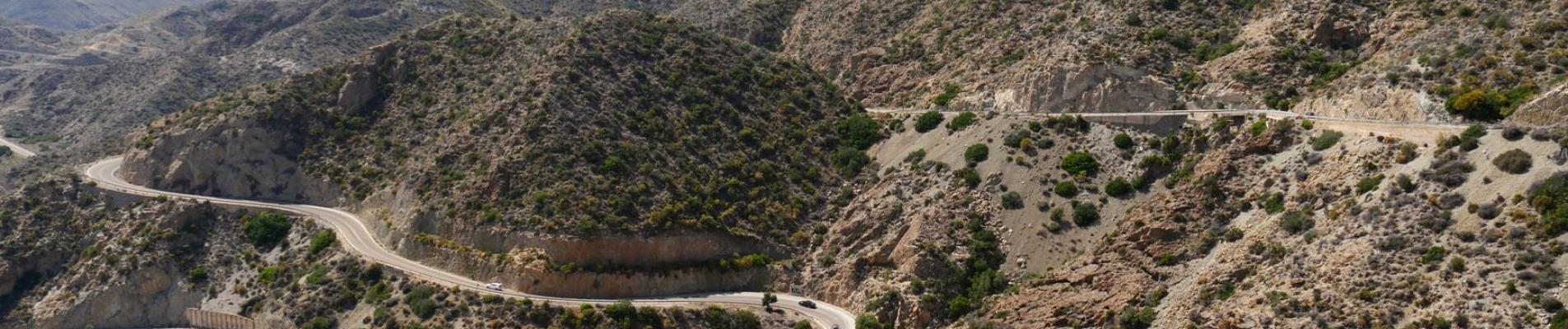 A winding road through the rugged mountains of Spain, offering a breathtaking view.