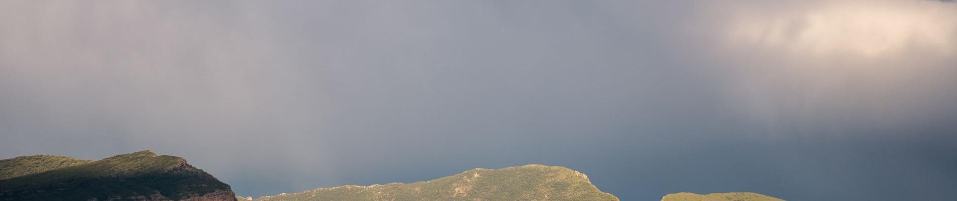 Scenic mountain landscape in Torallola, Spain with dramatic clouds.