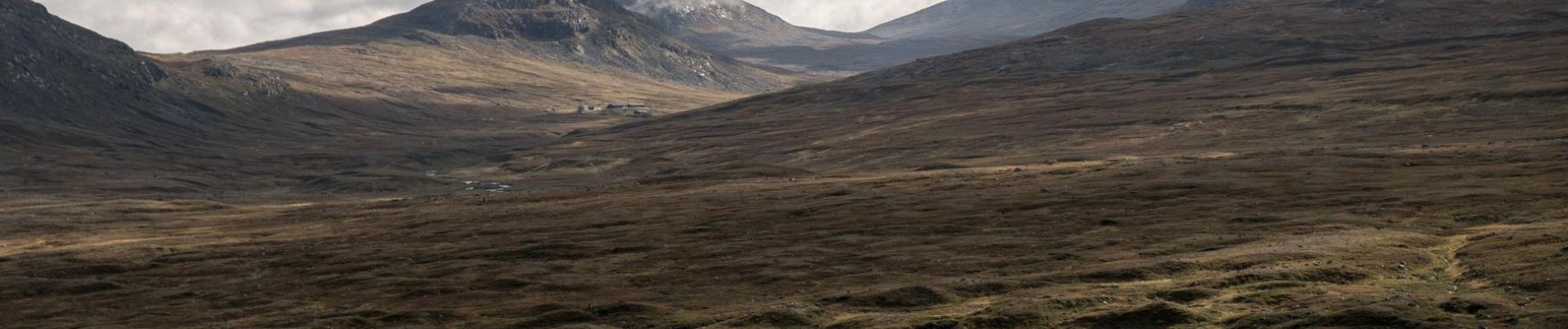 Expansive mountainous landscape under dramatic skies in Jämtlands län, Sweden.