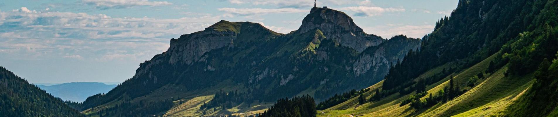 Breathtaking view of lush green valleys and mountains in Sennwald, Switzerland.