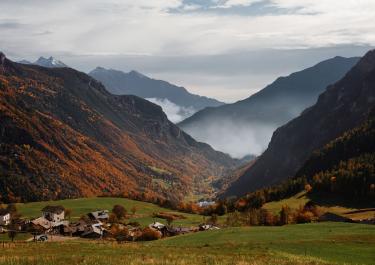 Idyllic autumn landscape in Valle d'Aosta, Italy with colorful foliage and mountain vistas.