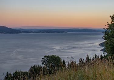 Beautiful sunset view over the calm waters and coastline of Trøndelag, Norway.