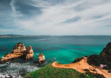 Arial view of Lagos' stunning coast with rock formations, clear sea, and lush landscape.