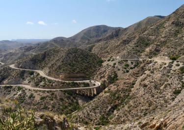 A winding road through the rugged mountains of Spain, offering a breathtaking view.