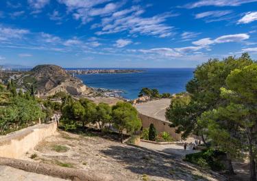 Stunning ocean and cityscape view from Alicante, Spain under a bright blue sky.