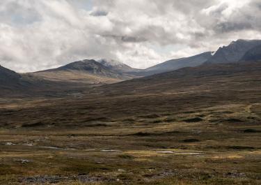 Expansive mountainous landscape under dramatic skies in Jämtlands län, Sweden.